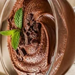 Creamy chocolate avocado mousse made with dates and cocoa powder, served in a small dessert bowl.